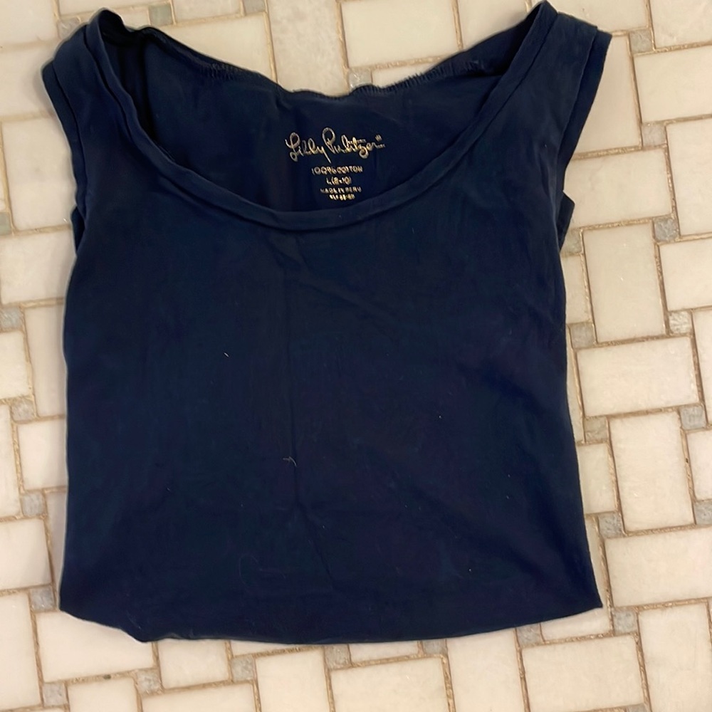 Lilly Pulitzer sleeveless t shirt navy blue with hot pink tassels at the bottom.